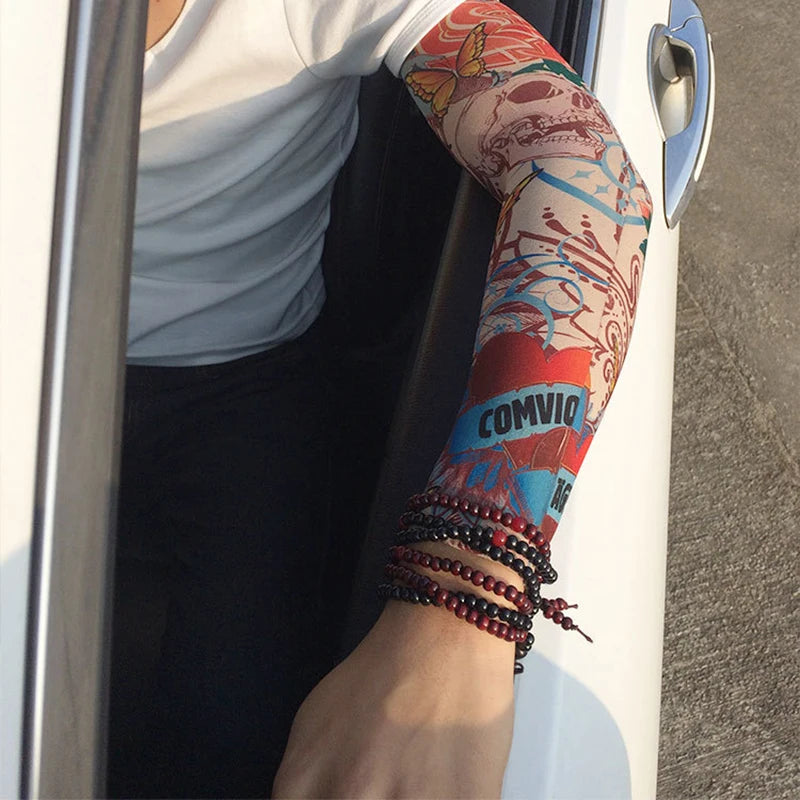 A person wearing long seamless tattoos on their arm, visible through a car window.