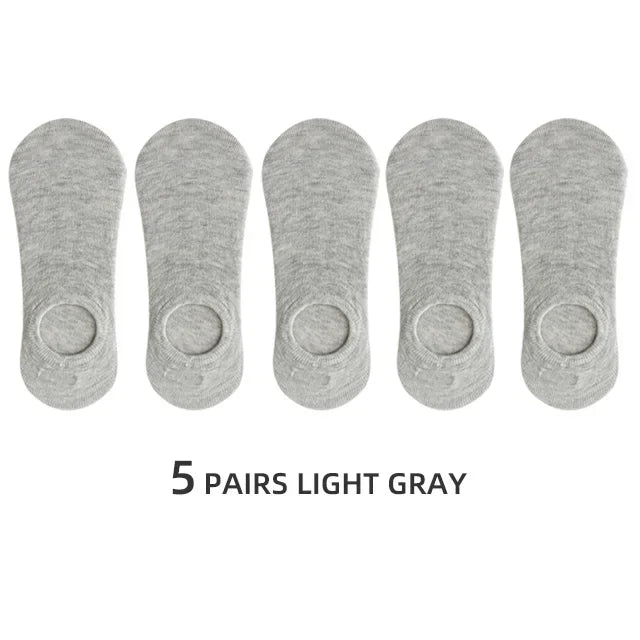 Five pairs of light gray men's invisible silicone no-show socks laid out side by side.