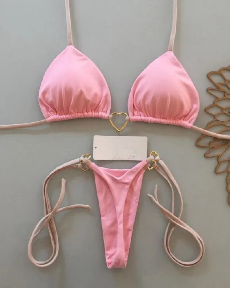 A pink halter bikini set for women displayed against a light gray background.