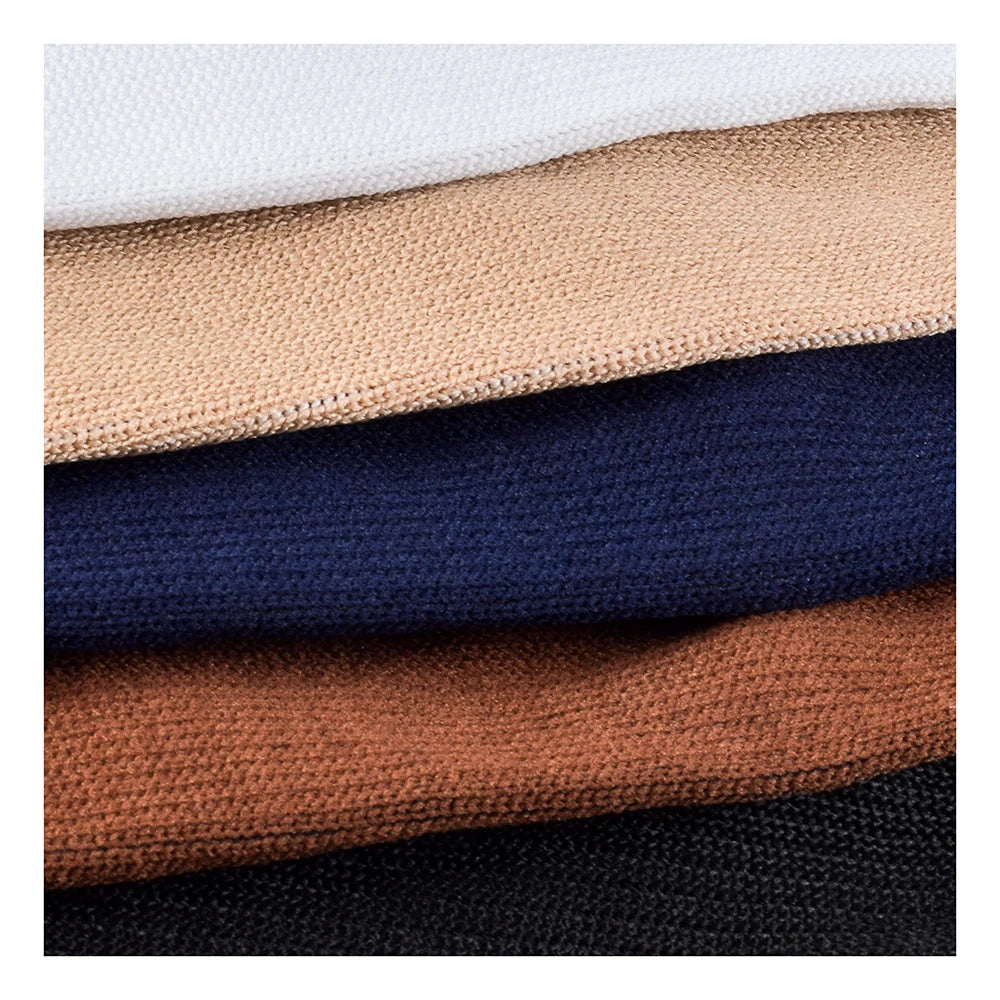 A stack of compression socks in various earth tones and dark blues, showing different shades of brown, beige, navy, and black