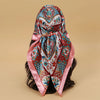 Elegant satin square scarf featuring intricate floral patterns in pink, blue, and white for hijab and hair