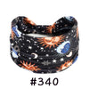 Black knotted cotton headband featuring celestial designs like moons, stars, and suns.