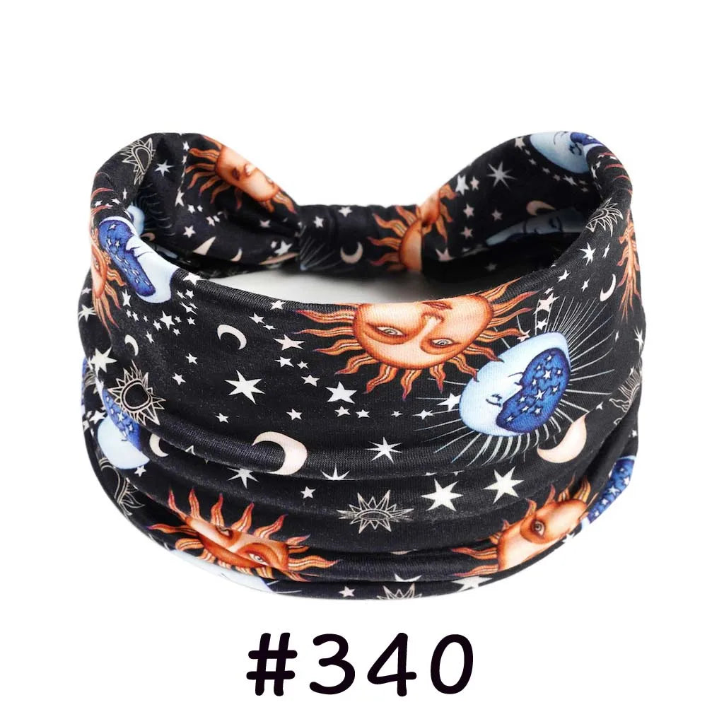 Black knotted cotton headband featuring celestial designs like moons, stars, and suns.