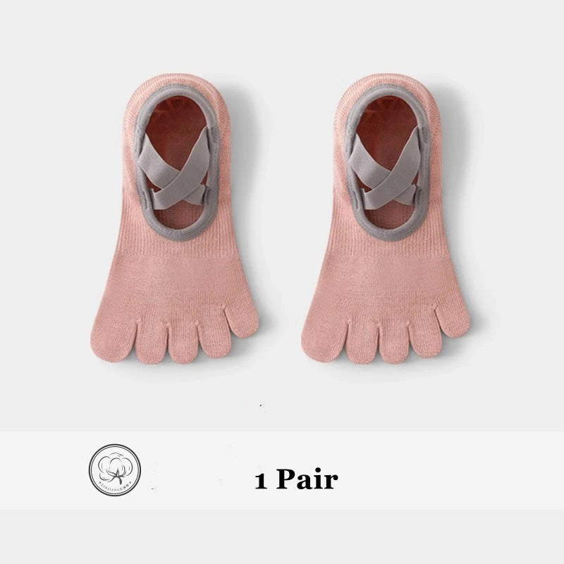 A pair of pink five-finger invisible yoga and fitness socks with gray accents.