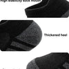 Close-up view of a black athletic sock showing features like a high elasticity mouth, thickened heel, and strengthening toes.