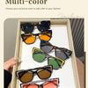 A collection of multi-color sunglasses displayed in a wooden box, showing various shades of black, orange, green, and brown.