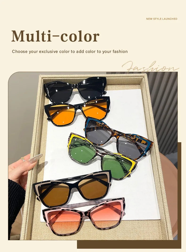 A collection of multi-color sunglasses displayed in a wooden box, showing various shades of black, orange, green, and brown.