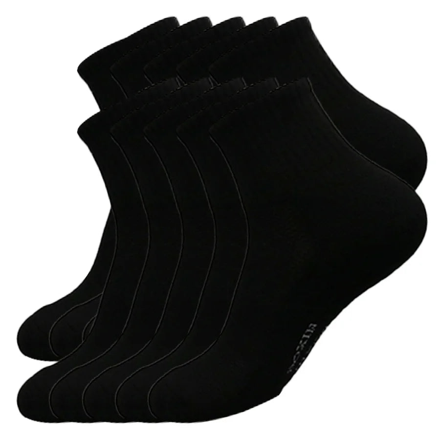 A stack of black men's essential warm socks for outdoor activities.