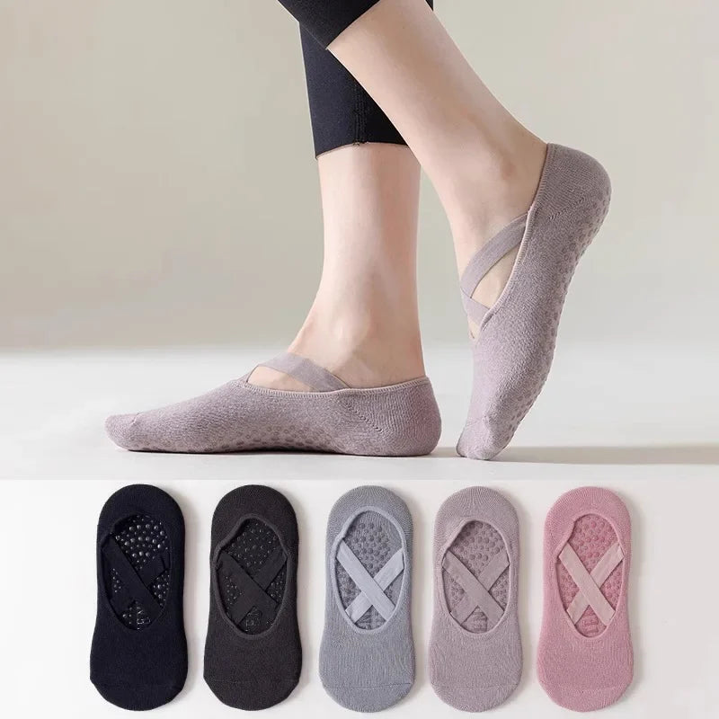 A pair of mauve non-slip yoga and gym socks with silicone grip shown on a person's foot.