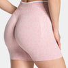 Light pink leopard print seamless yoga shorts worn by a person.