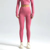 A model wearing seamless high-waist yoga leggings in a dusty rose color and a matching cropped top.