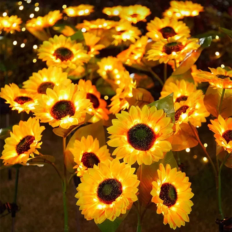 A close-up of bright yellow solar sunflower LED lights blooming on a plant.