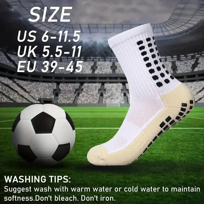 A pair of white soccer socks with black accents displayed on a green field background.