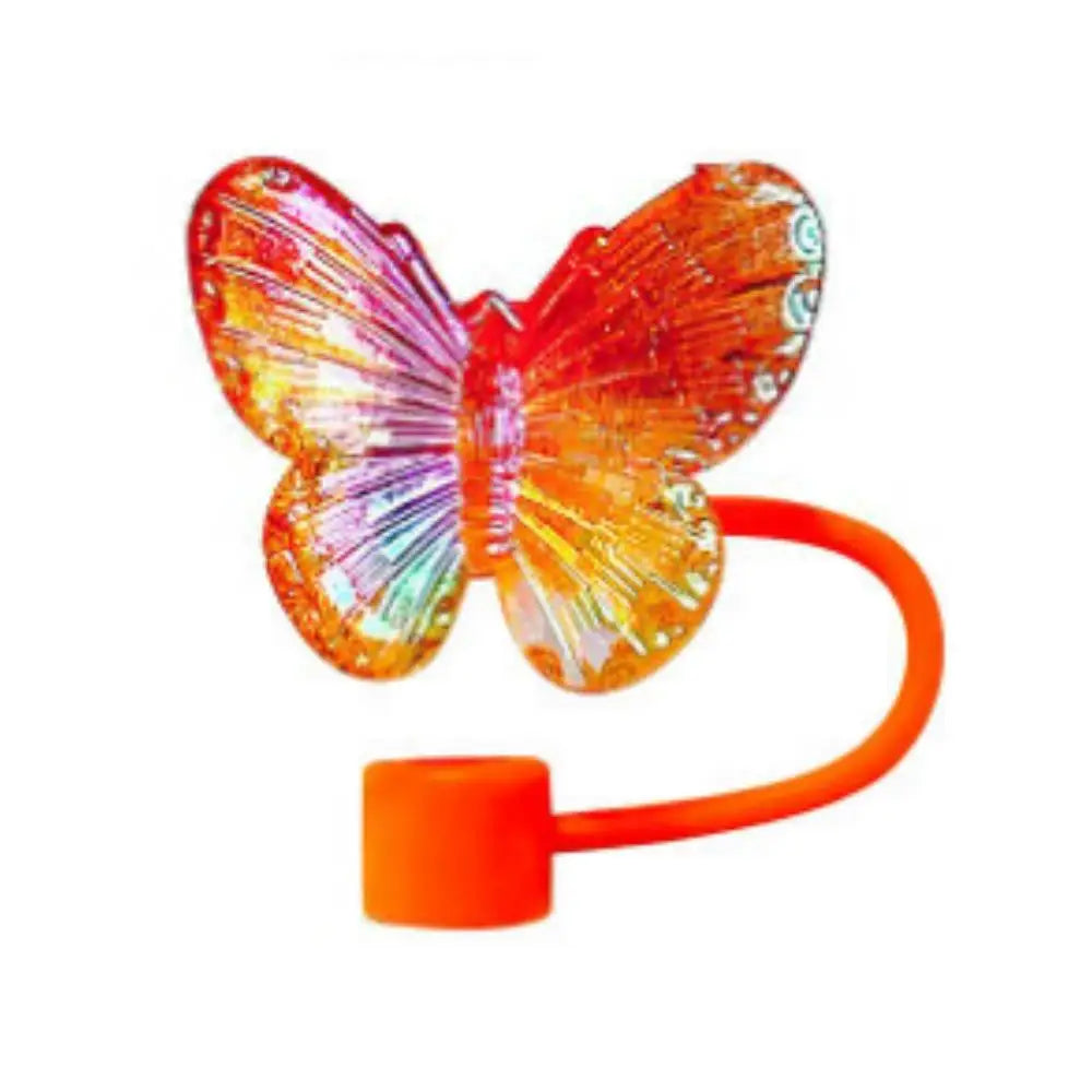 An orange silicone butterfly straw cover for tumblers.