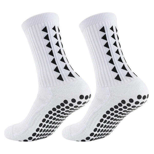 A pair of white non-slip athletic grip socks featuring black chevron and dot patterns.