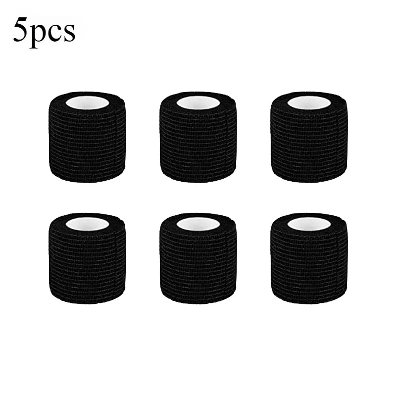 Five rolls of black tattoo grip bandage tape stacked horizontally.