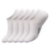 A set of white men's essential warm socks for outdoor activities, displayed in a row.