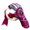 A pair of pink and blue high-performance goalkeeper gloves resting on a white soccer ball.