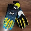 A pair of black and yellow durable riding gloves for motorcycle and off-road sports displayed on a wooden surface.