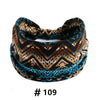 A close-up of a patterned boho cotton turban headband featuring brown, black, and teal geometric designs.