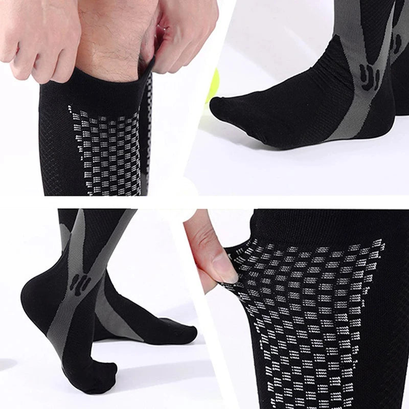 Close-up view of black compression socks with gray mesh detailing, showing the texture and fit.