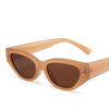 Tan acetate sunglasses with a cat eye shape and small rhinestones