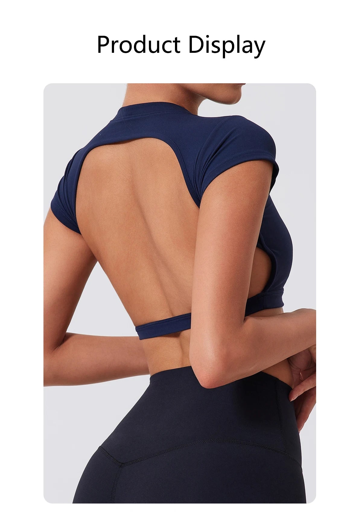 A woman wearing a navy blue women's fitness crop top yoga and gym t-shirt, shown from the back.