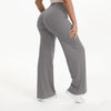 A person wearing gray NCLAGEN SoftMotion straight leg yoga pants standing and looking down.