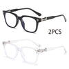 A pair of black square blue light blocking glasses and a pair of clear frame lenses are shown.