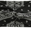 Black and white paisley patterned women's elastic sports headband tied in a bow
