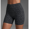 Un mannequin porte des shorts de yoga taille haute à imprimé léopard gris foncé.
