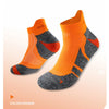 A pair of orange performance sports ankle socks with gray accents shown from the side.