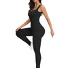 A woman models a black ribbed nylon bodycon jumpsuit with white sneakers.