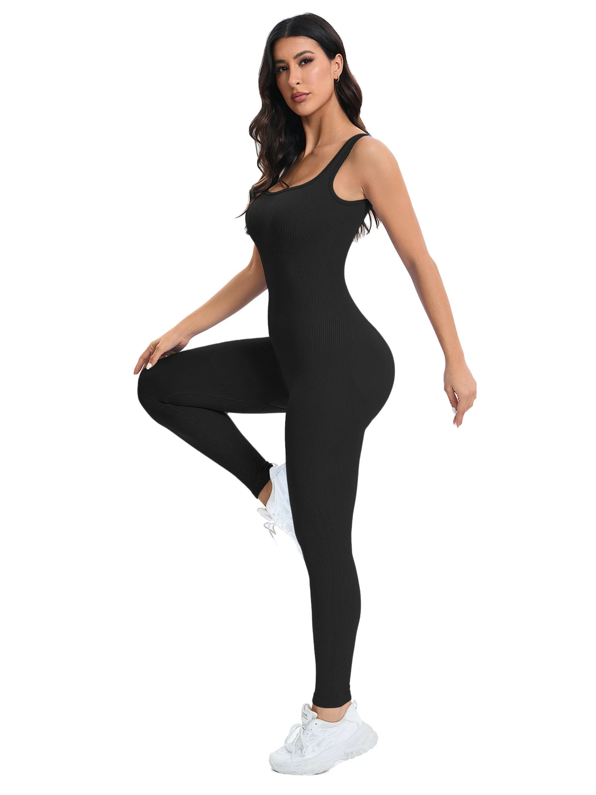 A woman models a black ribbed nylon bodycon jumpsuit with white sneakers.