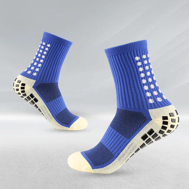 Un par de calcetines deportivos para fútbol azules y beige antideslizantes para hombres, vistos de lado.