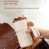 A white thermo mug with a brown lid is being held, demonstrating its sealed and leakproof design.