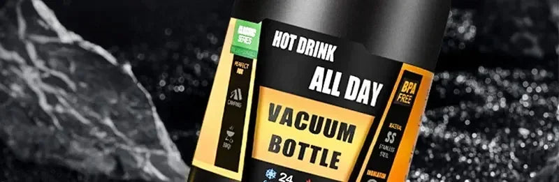 A close-up of a black insulated vacuum bottle with an all day hot drink label and BPA free designation.