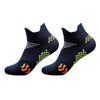 A pair of dark blue cycling and running socks with a green pattern and orange accents.