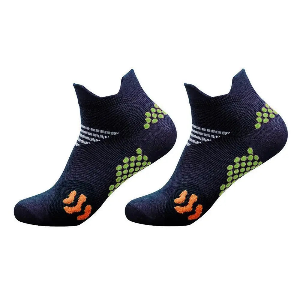 A pair of dark blue cycling and running socks with a green pattern and orange accents.