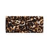 A close-up of a black and tan leopard print fabric used as a headband or scarf.