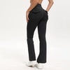 A person wearing black high-waisted flared yoga leggings with a front pocket detail.
