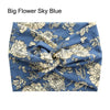 Blue fabric headband with a floral pattern, featuring light beige and white flowers.