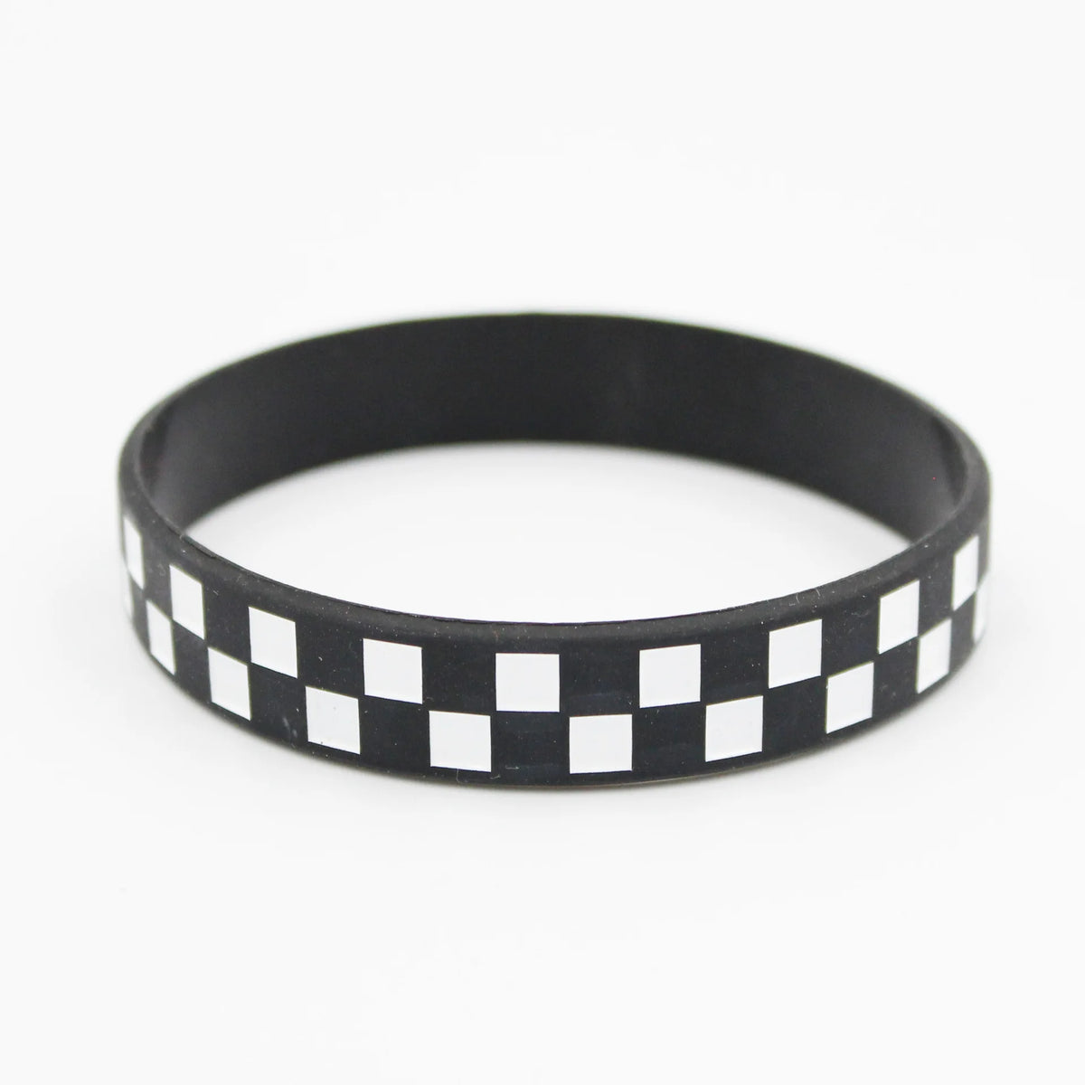 Black silicone wristband with a white checkered pattern.