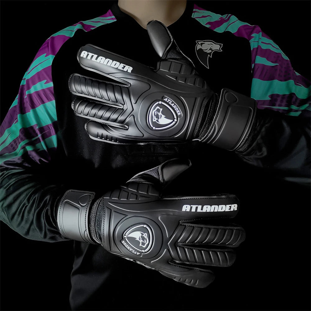Black latex goalkeeper gloves with the Atlander logo worn by a person.