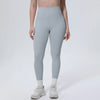 A model wearing light blue high-waisted quick-drying yoga and fitness leggings with white socks and white athletic shoes.