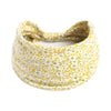 Large yellow bohemian print headband hair wrap tied in a bow.