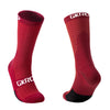 A pair of red cycling socks with black accents shown from the side.