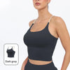 A model wearing a dark gray summer strappy yoga sports bra with built-in padding.