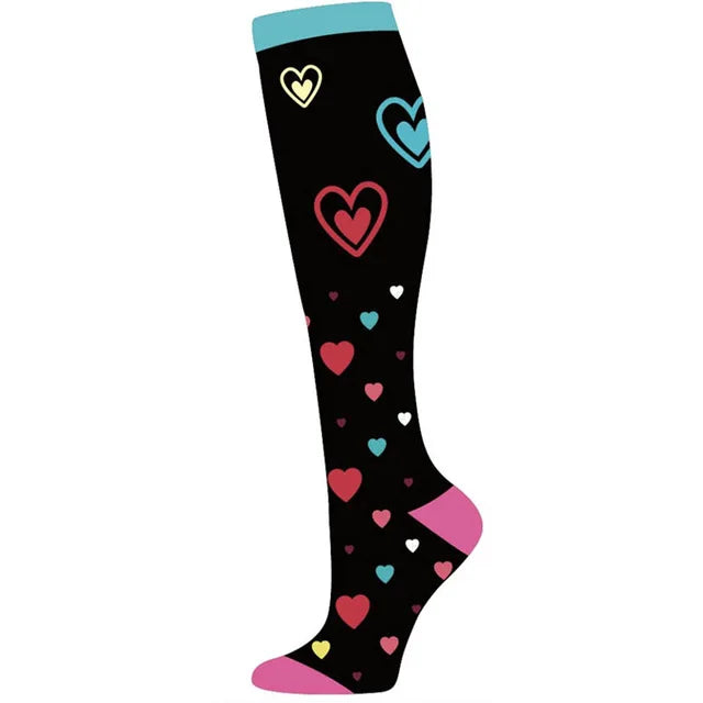 Black compression socks with heart patterns and a pink toe section.