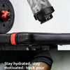 A close-up of a clear portable electric shaker bottle being shaken, with a black and red accessory visible.